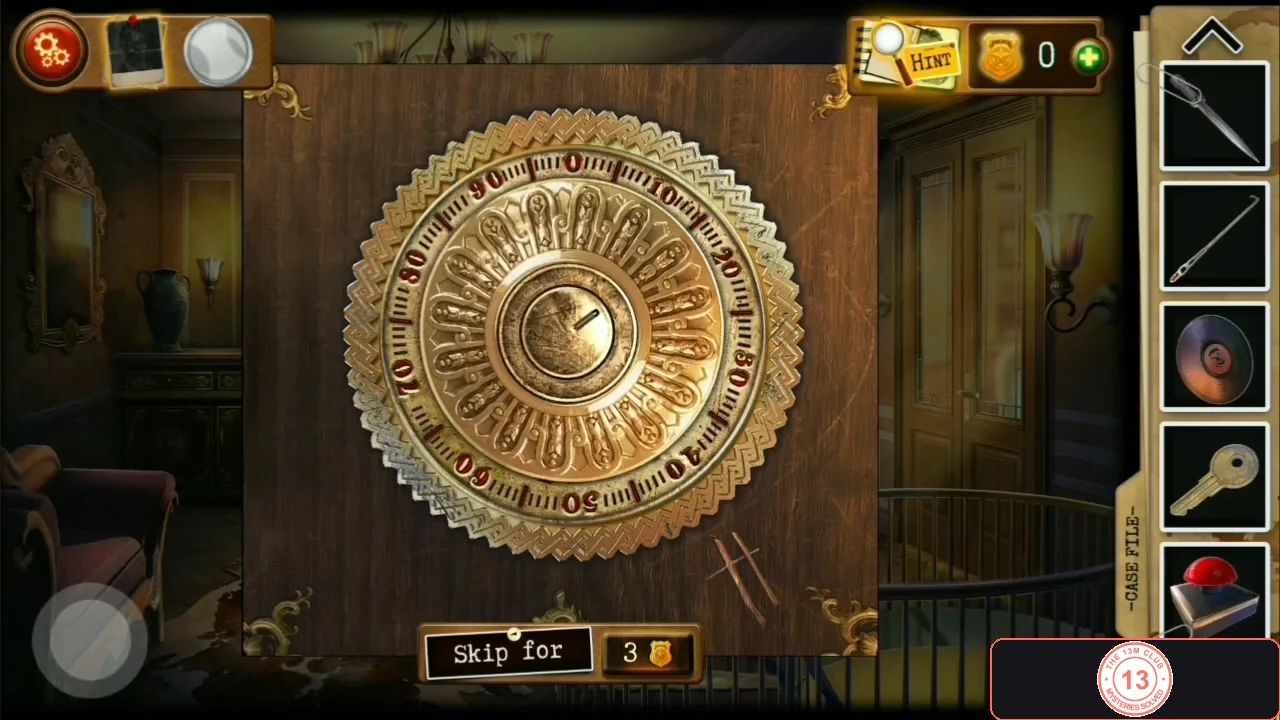 Round brass dial lock numbered 0 to 90 with two scratch lines on the wood below it to the right