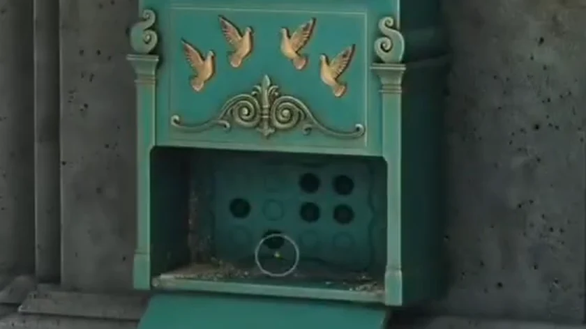 Opened lower compartment of the LETTERS mailbox showing a 3x4 panel with six dark holes