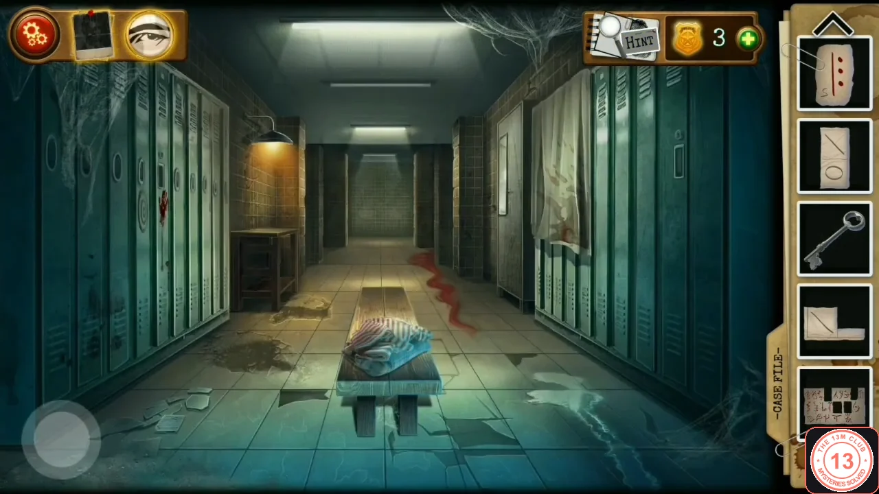 Green locker corridor with a bench in the middle, a bloodstain on the floor and the shower at the far end