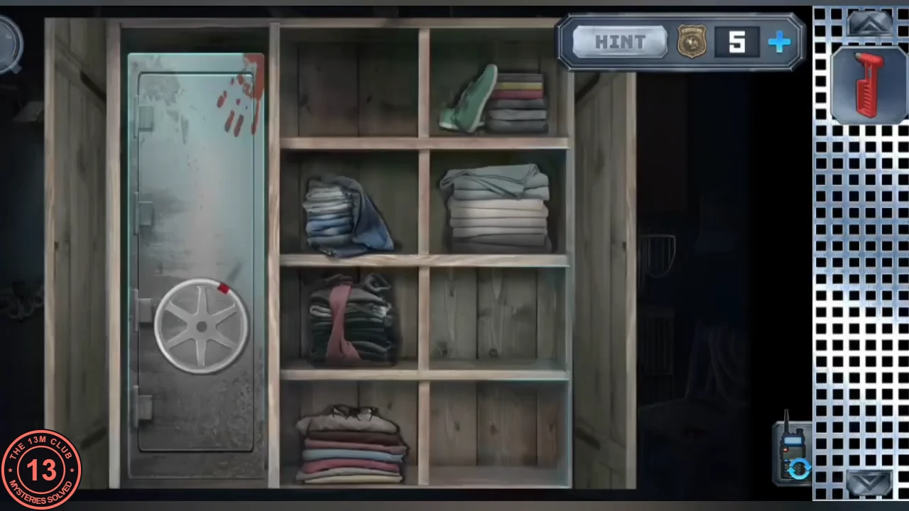 The peacock wardrobe opened: a metal safe with a wheel lock on the left and shelves of folded clothes on the right