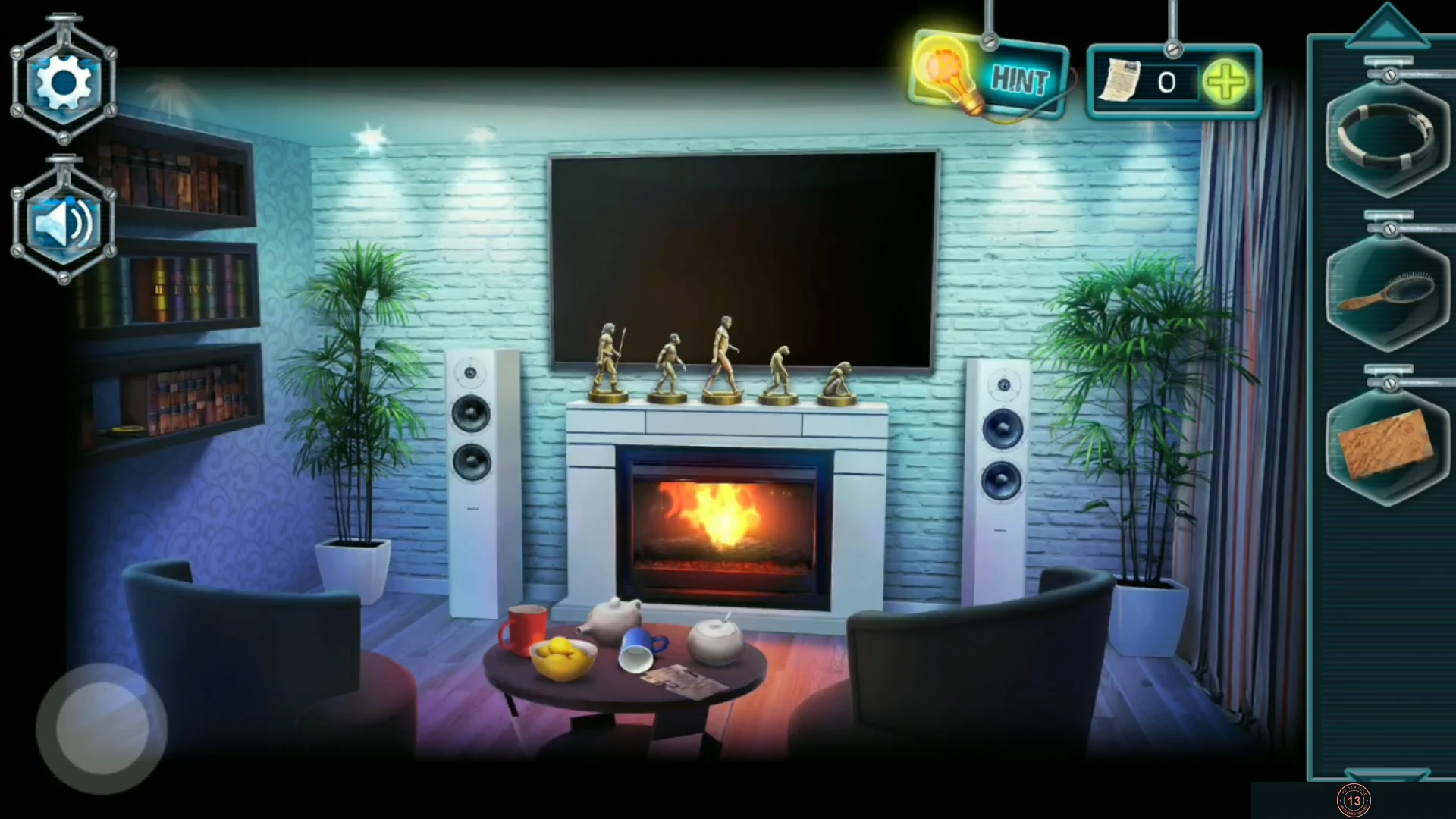 Living room with the fireplace, five bronze figurines on the mantelpiece, TV, bookshelf and coffee table