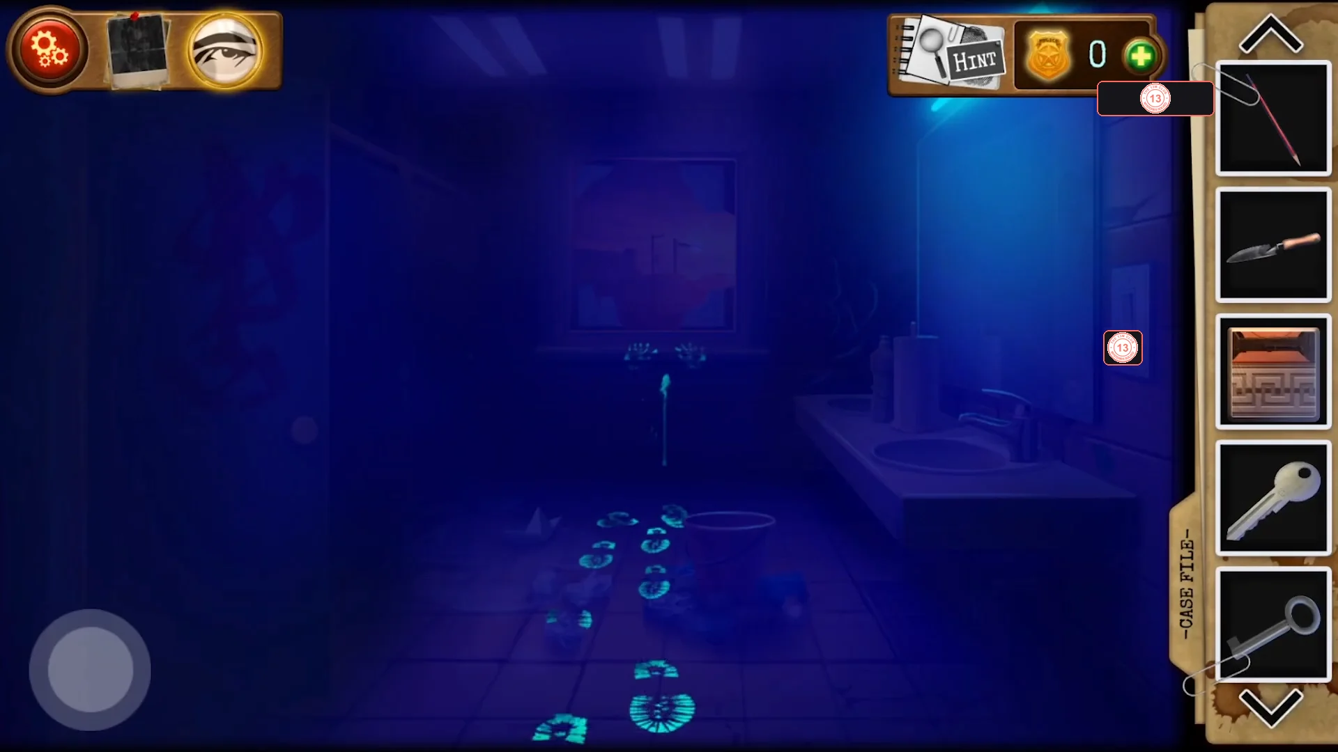 The restroom in dark blue light with glowing footprints on the floor leading from the window towards the camera