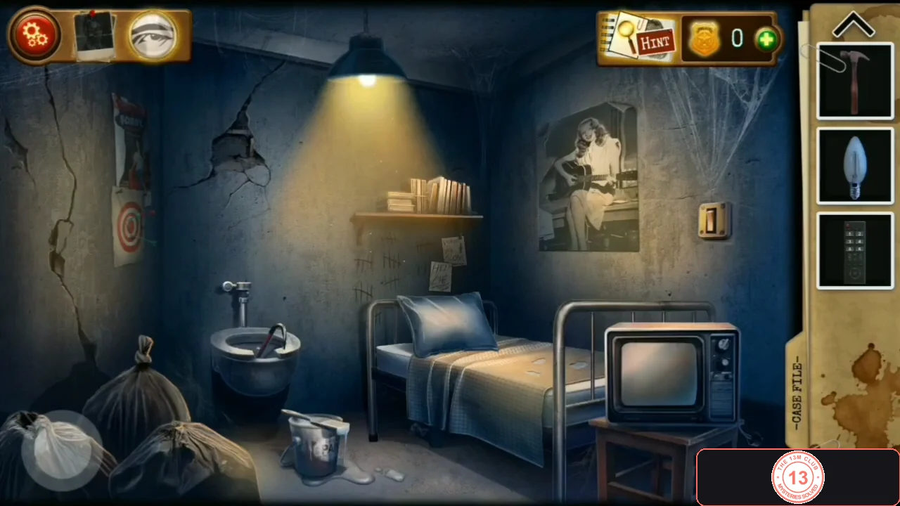 Prison cell with a cracked left wall, toilet, bed, a TV on a stool and a light switch on the right wall