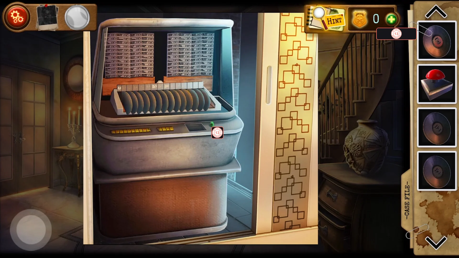 Old jukebox revealed behind a sliding wall panel, with a record rack and a console