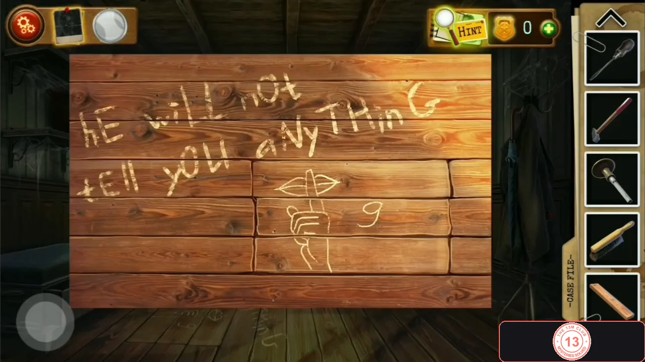Floorboards carved with the words HE will not tell you anyThinG, a hand making a shush sign and the number 9