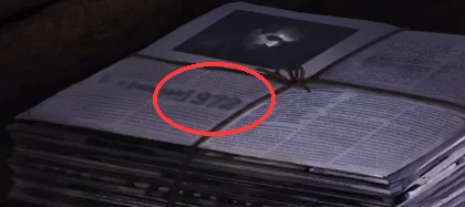 Close-up of the tied bundle of newspapers, with the year 1972 printed in large digits on the top paper's left-hand page circled.
