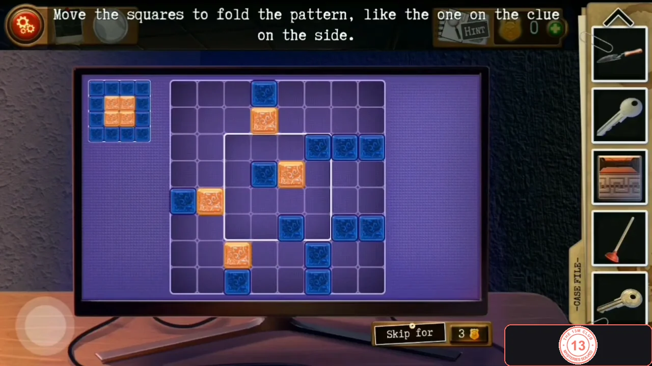 Computer screen with scattered blue and orange squares on a grid and a small target clue in the top-left corner