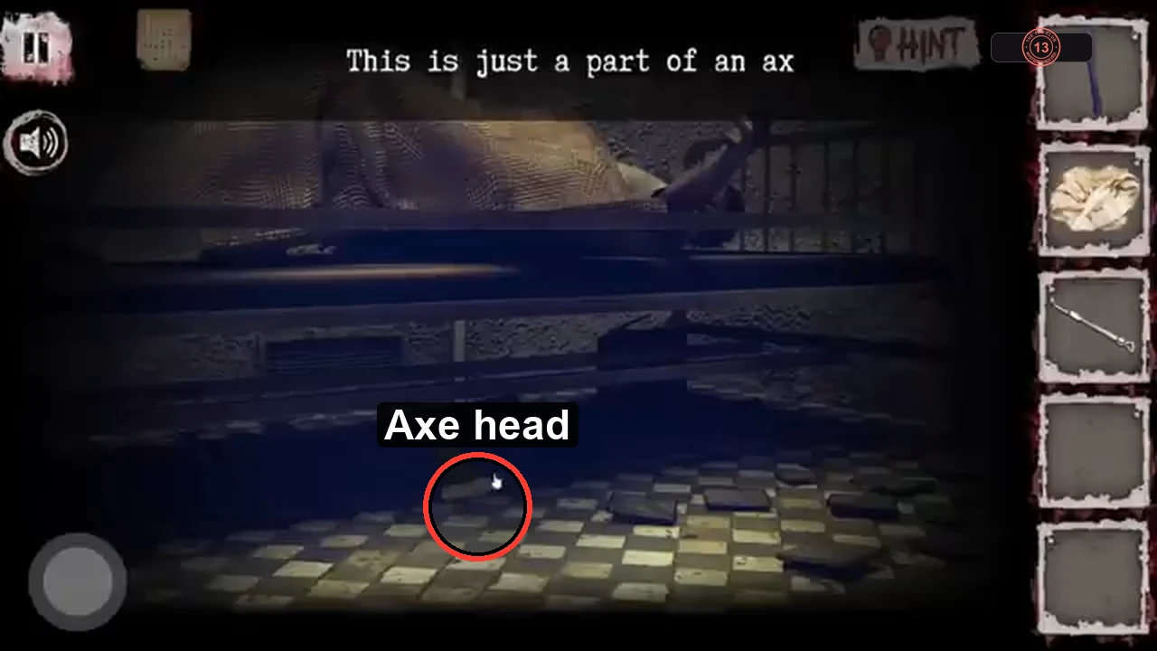 View under the bed with the dark axe head circled on the floor