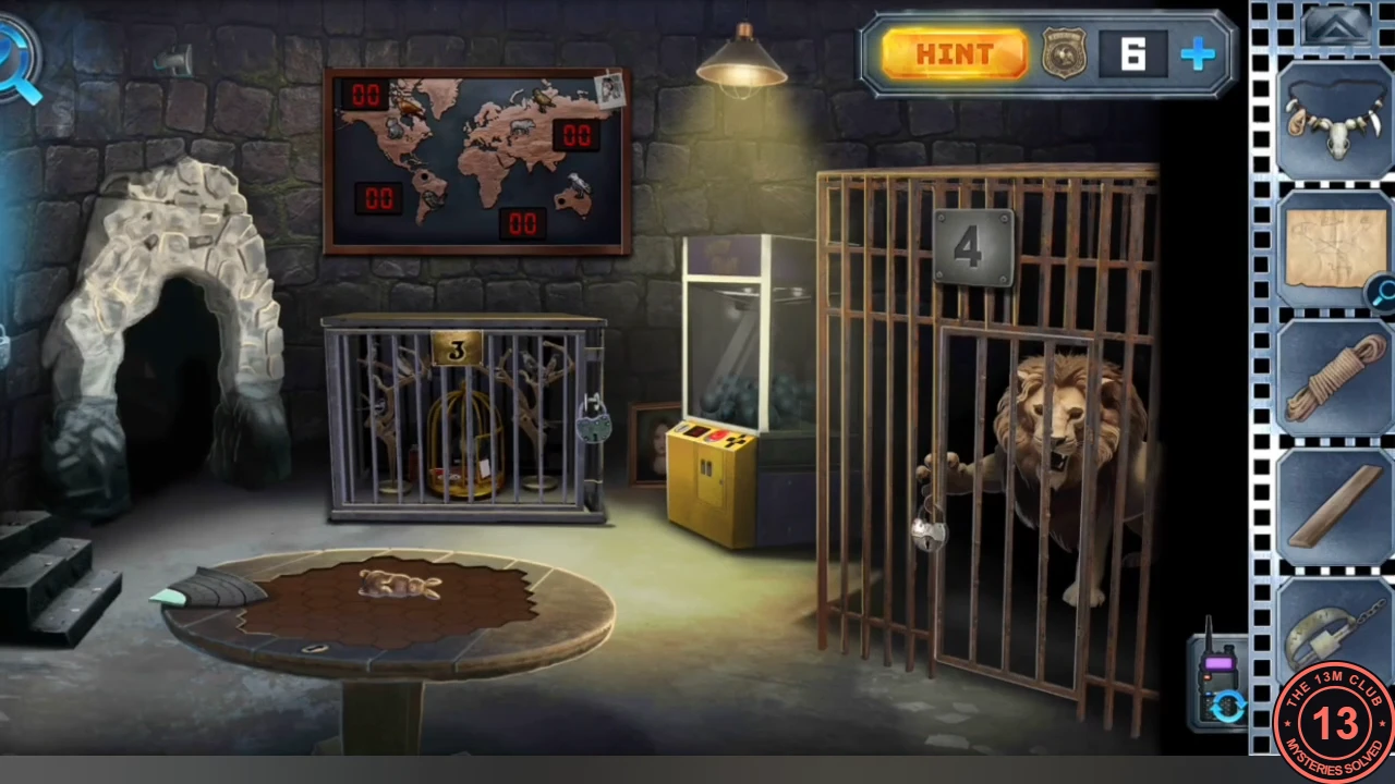 Zoo room with a stone cave on the left, a world map with four red 00 score boards, raven cage 3, a yellow claw machine, the lion behind the bars of cage 4 and a round table with a wind-up rabbit in the foreground