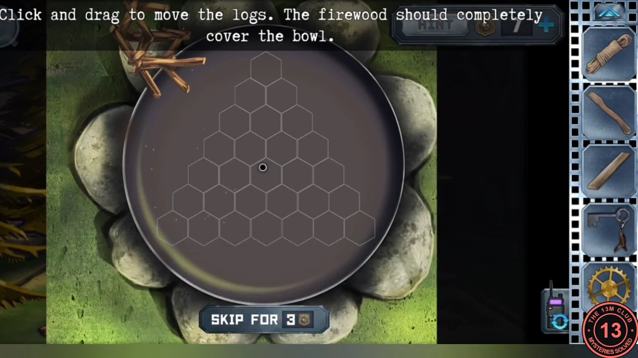 The empty fire pan on its ring of stones with a triangle of hexagon outlines inside and the firewood bundle at the top left, with the instruction that the firewood should completely cover the bowl.