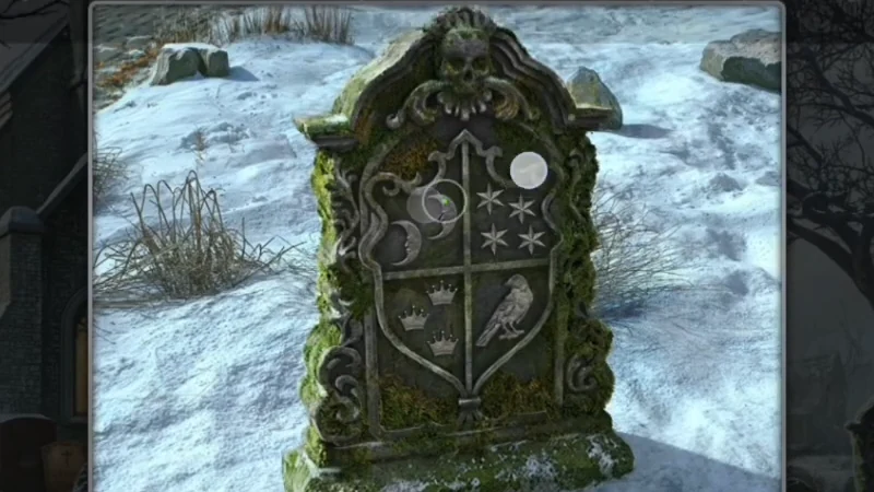 Cleaned green tombstone with a crest: two crescent moons, a full moon with stars, three crowns and a raven
