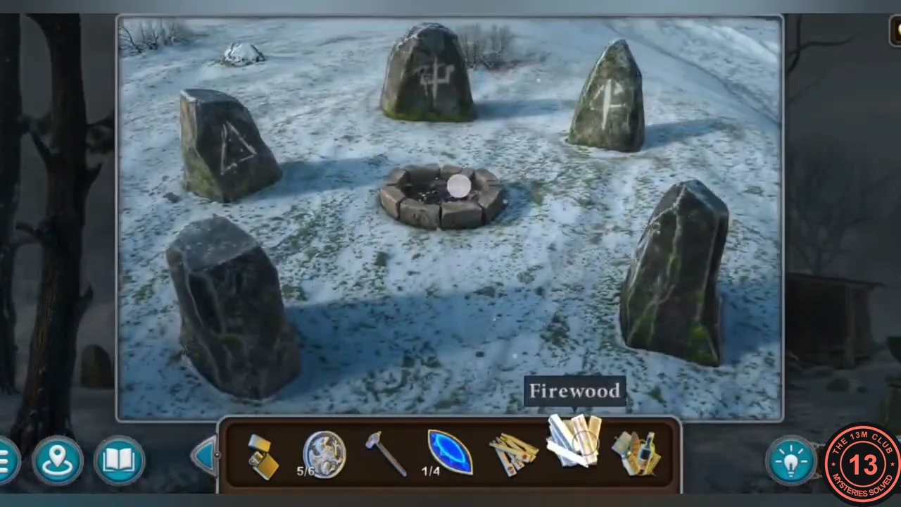 Stone fire pit between standing stones in the snowy yard of the burned house