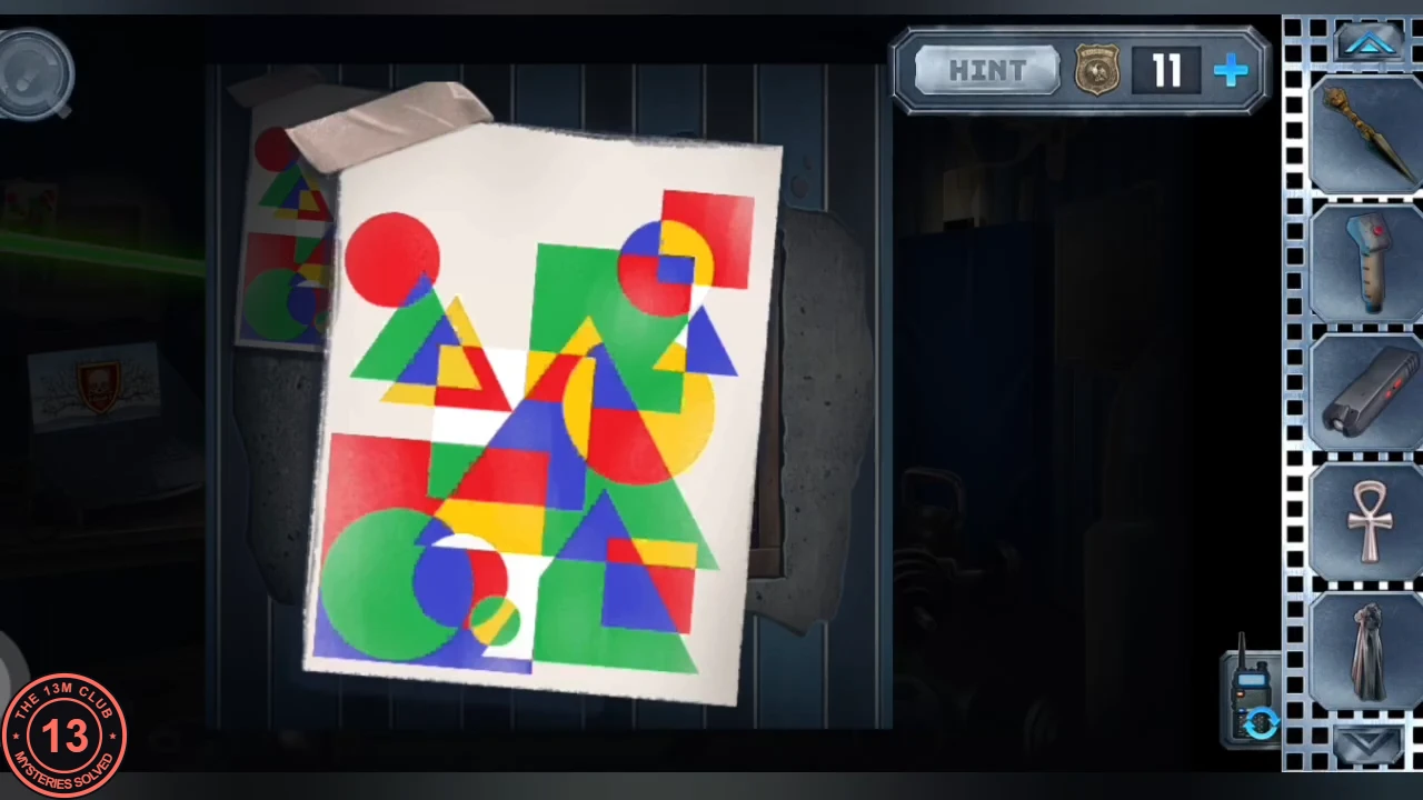 Abstract painting of overlapping red, blue, green and yellow circles, squares and triangles, pinned beside the locker-room crate