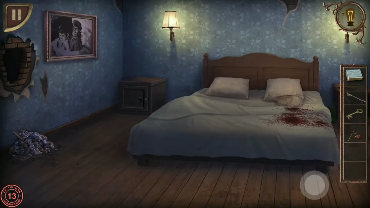 A blue bedroom with a blood-stained bed, a closed nightstand to the left of the bed and a broken hole in the wall at the left.