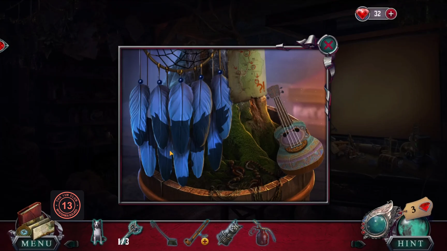 Dreamcatcher with blue feathers hanging from the tree, beside the ukulele
