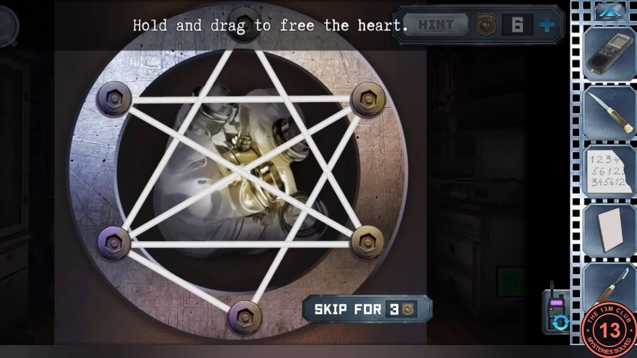 The cabin mannequin's open chest: a metal artificial heart behind white rubber bands stretched in a pentagram between six bolts; instruction 'Hold and drag to free the heart'