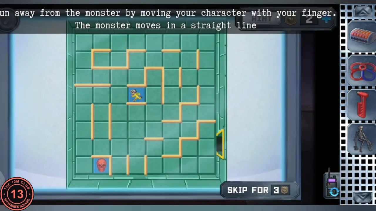 Green tiled maze on the workshop TV with orange wall segments, a yellow runner near the top middle, a red skull monster in the bottom left and the exit on the right edge; instruction about running away from the monster that moves in a straight line.