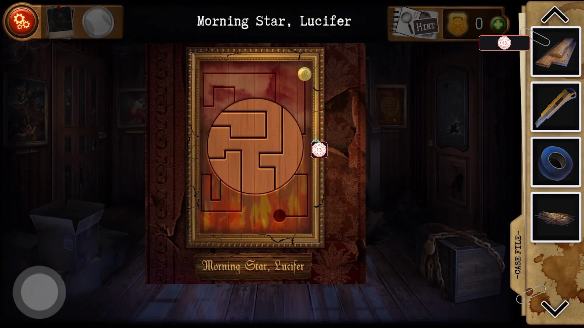 The Morning Star, Lucifer frame showing a wooden maze with a rotating round centre disc, the gold badge at the top right and a dark hole among the flames at the bottom