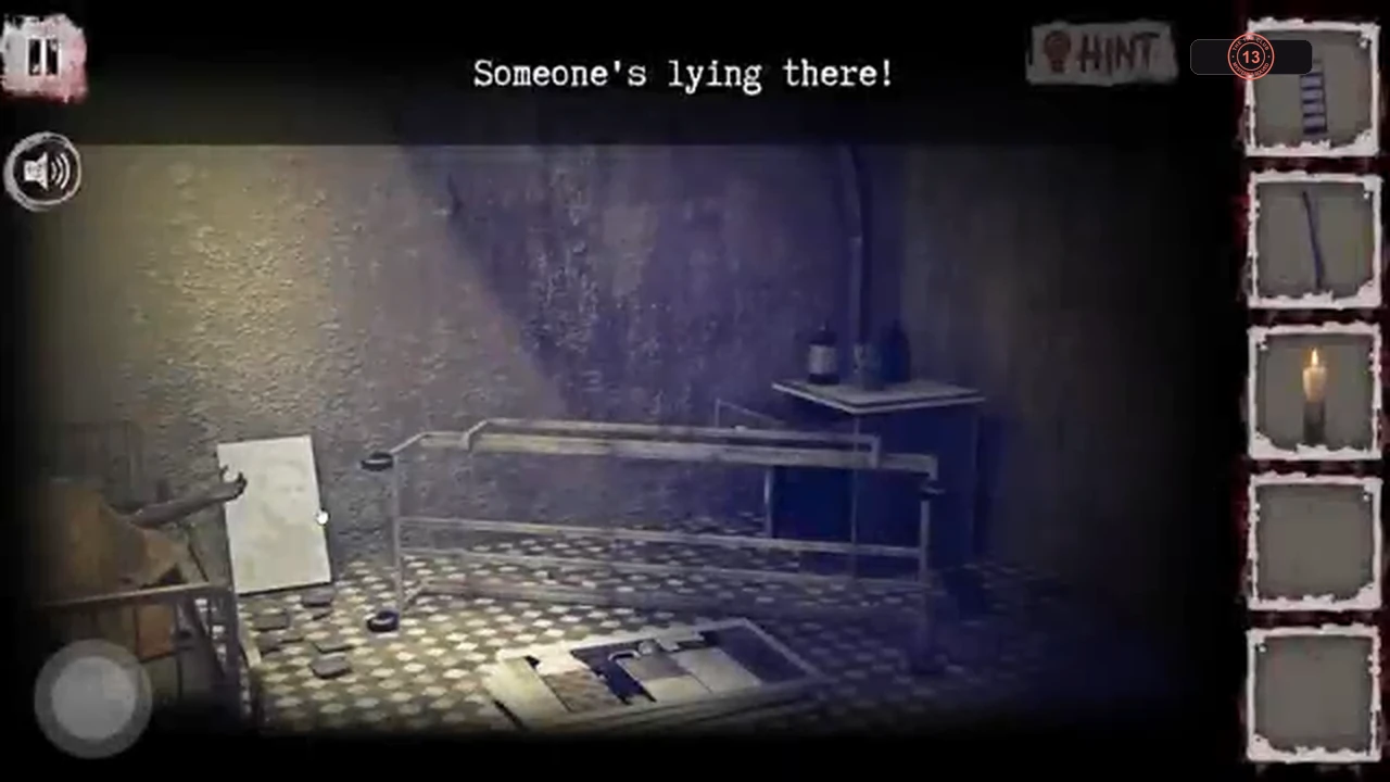 Basement room with a patient lying under a sheet on a bed and a white board leaning nearby