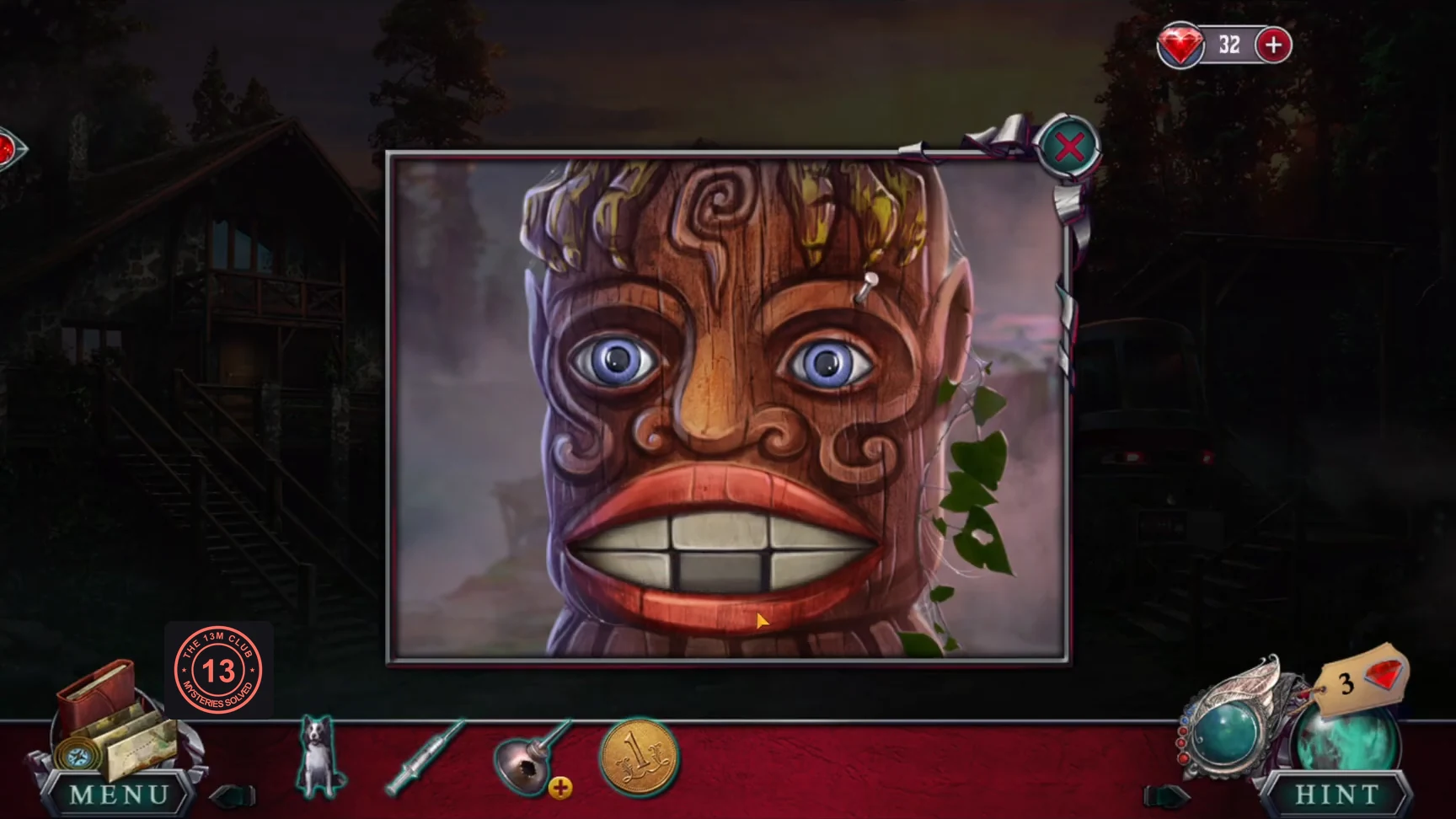 Carved totem face with its mouth closed, showing the teeth