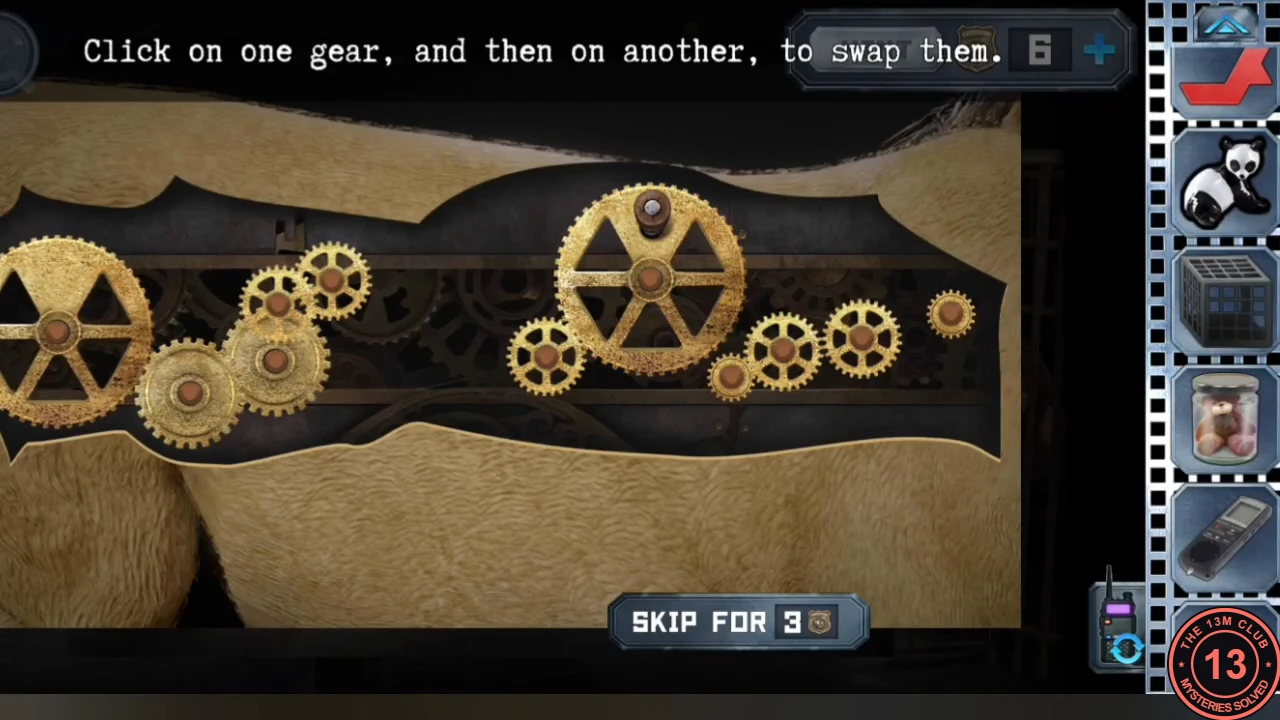 Open panel in the lion's side showing a row of brass gears of different sizes with gaps in the drive train; instruction 'Click on one gear, and then on another, to swap them'