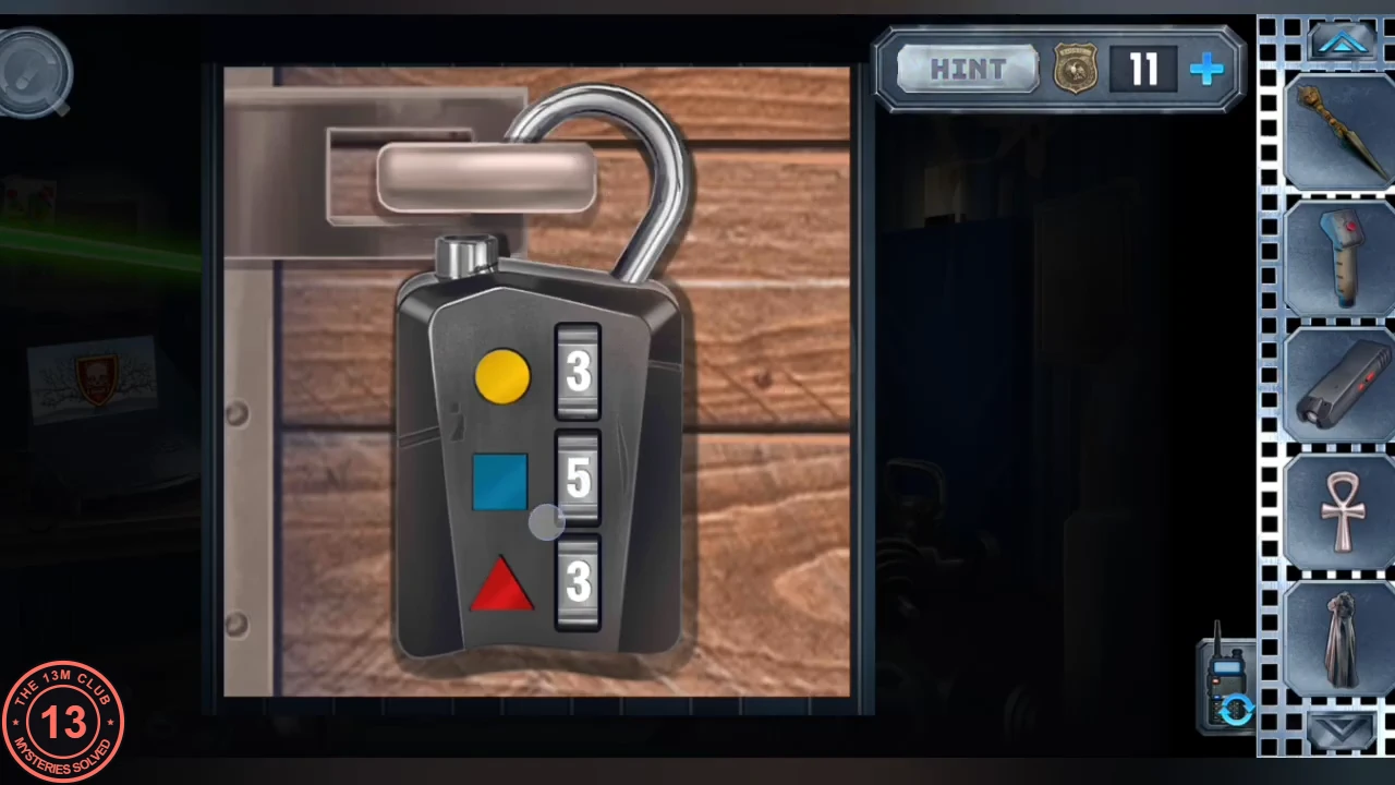 The crate padlock with its shackle sprung open, wheels reading 3 for the yellow circle, 5 for the blue square and 3 for the red triangle