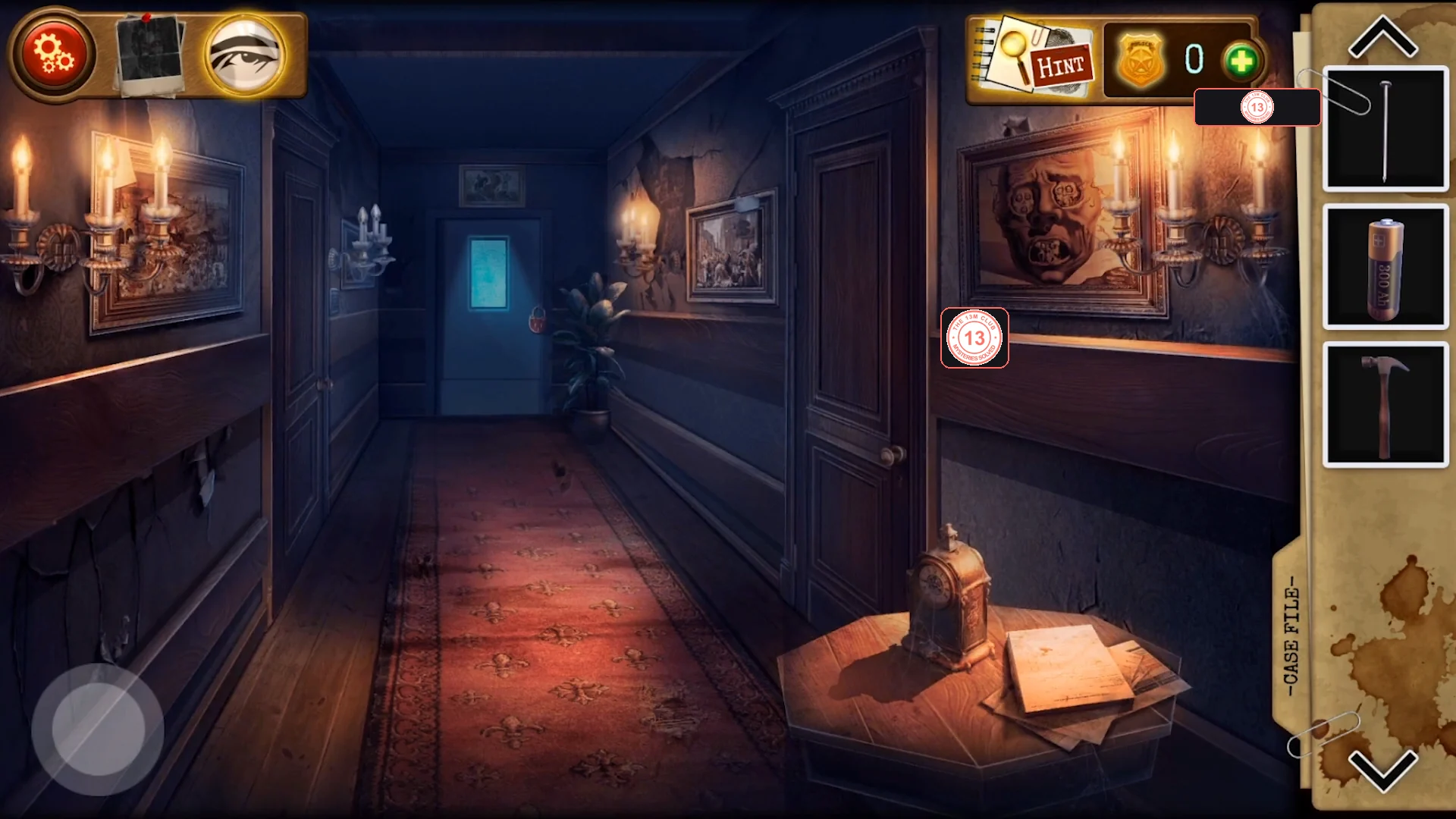 Carpeted corridor with small paintings on both walls, a keypad door at the far end and a side table in the foreground