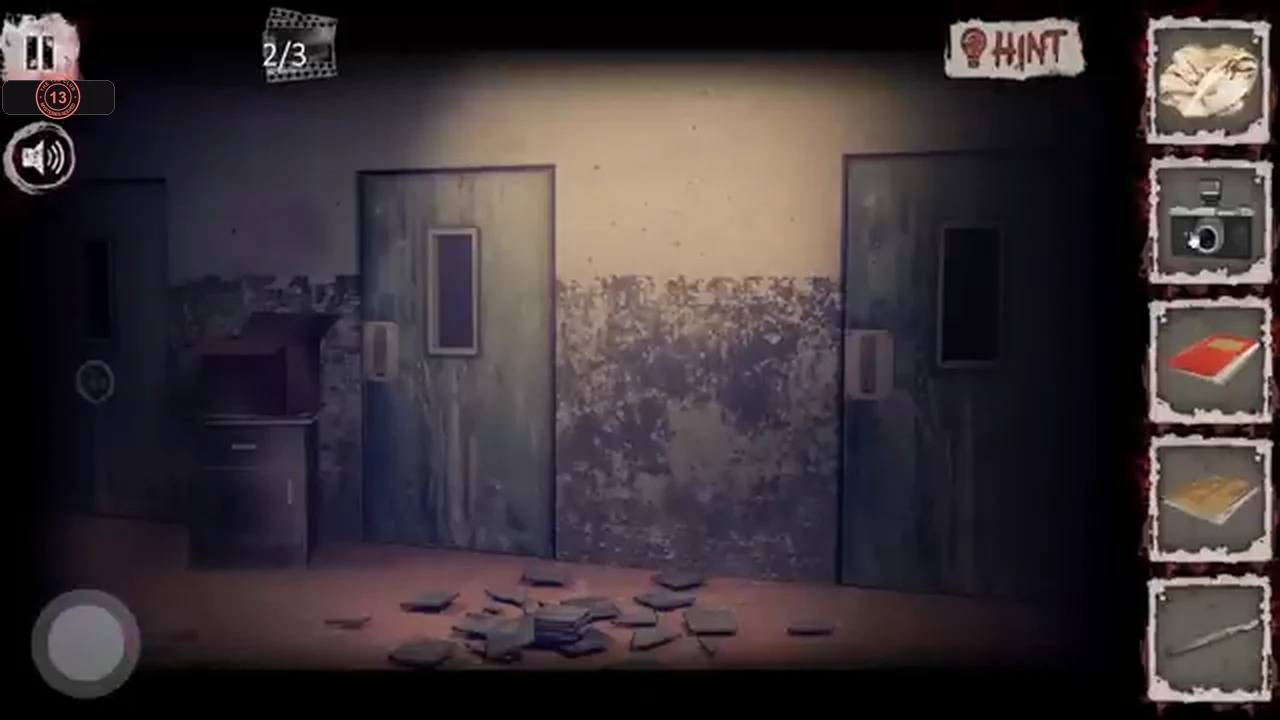 Second basement corridor with two metal doors and a dirty wall