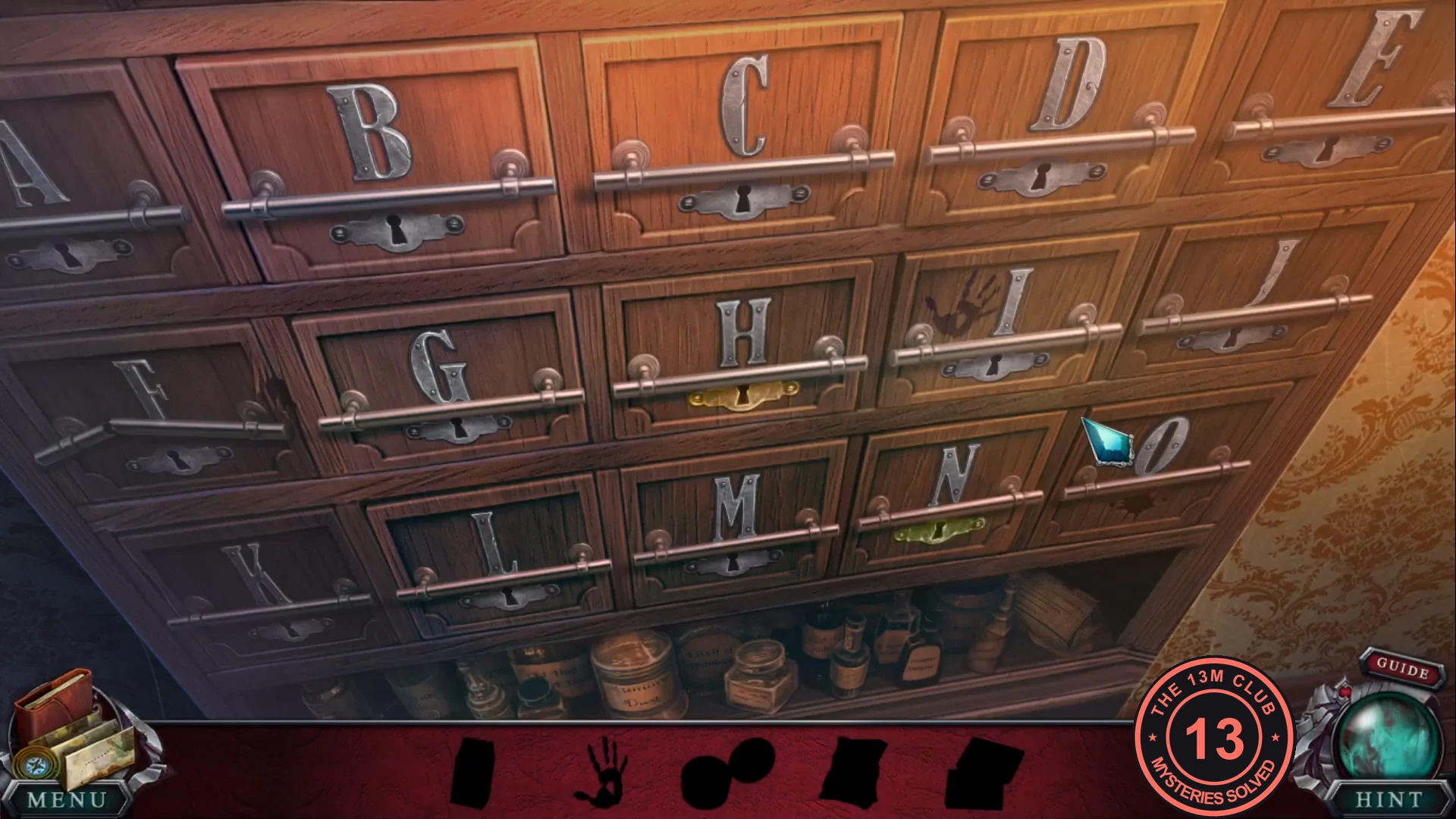 Cabinet of lettered drawers with silhouettes of the wanted items at the bottom