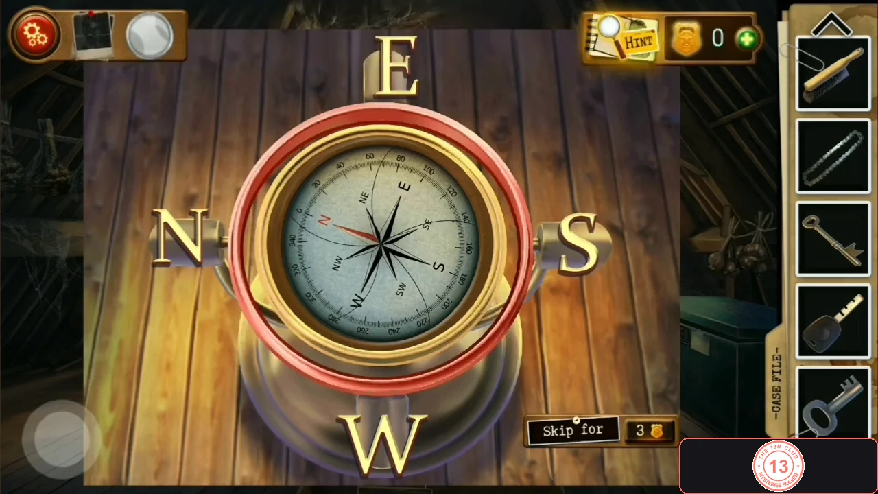 Brass compass on a pedestal with the letters E at the top, N on the left, S on the right and W at the bottom